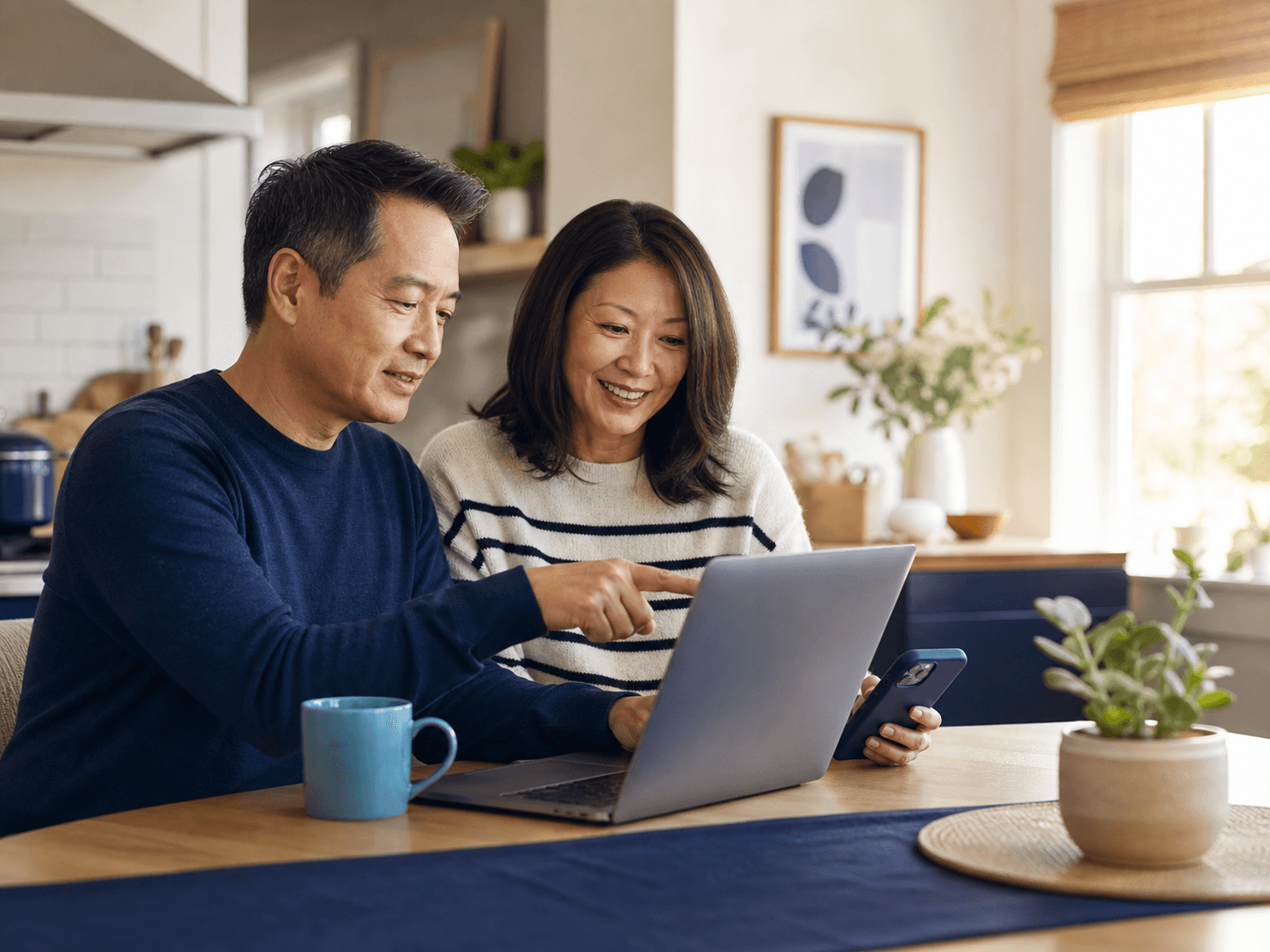 A couple calmly reviewing helpful information together at their kitchen table